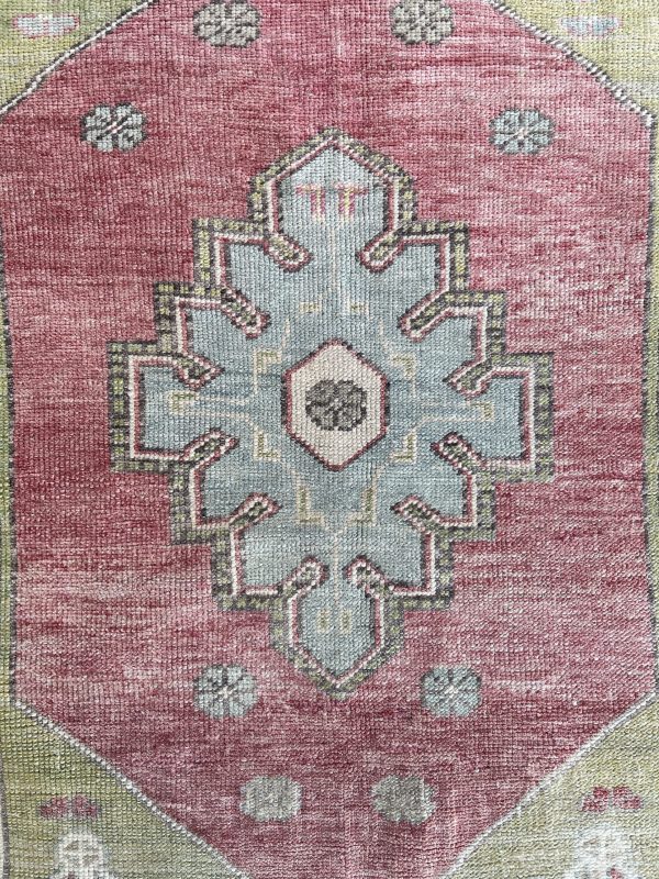 Hand-knotted Turkish wool rug with faded details