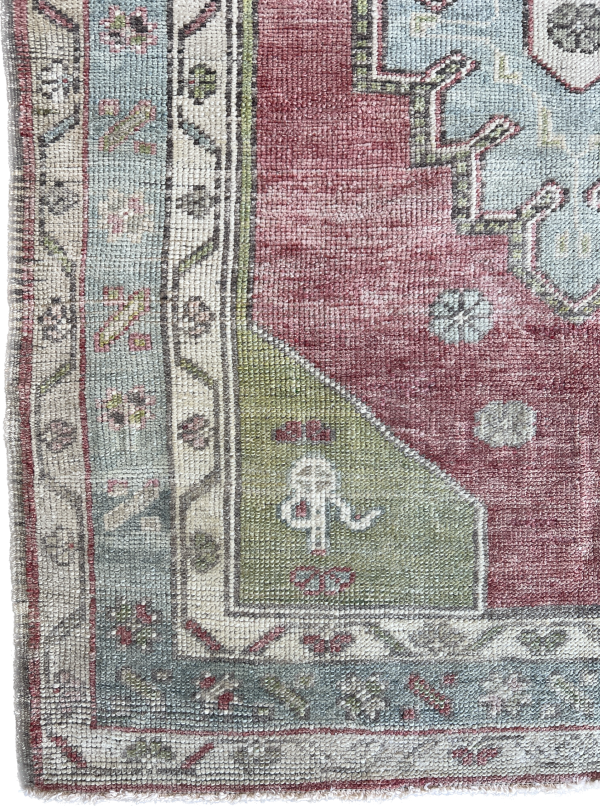 Small handwoven Turkish rug with traditional motifs